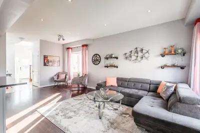 a living room with a couch and a glass table at GlobalStay 3 Bedroom Townhome with Hot Tub Hamilton in Hamilton