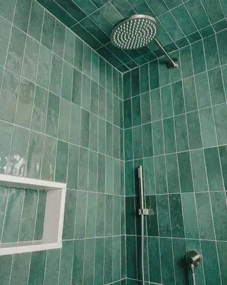 a green tiled bathroom with a shower with at Penny's Motel in Thornbury
