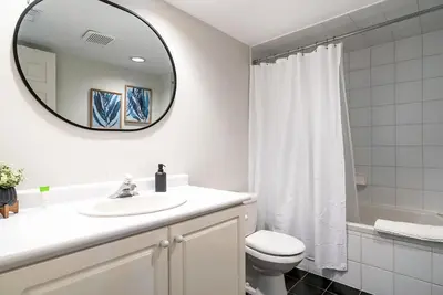 a white bathroom with a sink and a mirror at Luxurious Blue Mountain 3BR & 3BTH Walk-in to Village in Blue Mountains