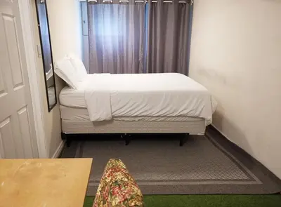a small bedroom with a bed and a window at Private Rooms in House in North York Shared Kitchen in Toronto