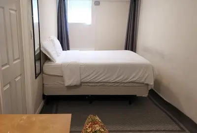 a small bedroom with a bed and a mirror at Private Rooms in House in North York Shared Kitchen in Toronto