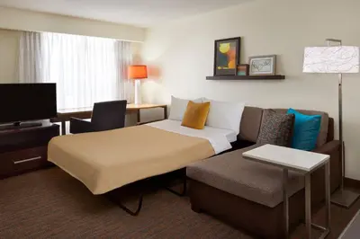 a hotel room with a bed and a couch at Residence Inn by Marriott Toronto Airport in Toronto