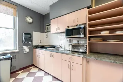 a kitchen with white cabinets and a sink at Guest House on the Mount in London