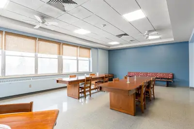 a conference room with wooden tables and chairs at Guest House on the Mount in London