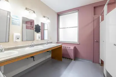 a bathroom with two sinks and a large window at Guest House on the Mount in London