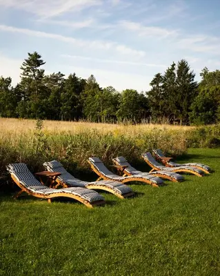 a row of chairs sitting in the grass at The Eddie Hotel and Farm in Bloomfield