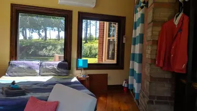 a bedroom with a bed and a window at The Front Porch Room of a 140-Year-Old Victorian House in Orangeville