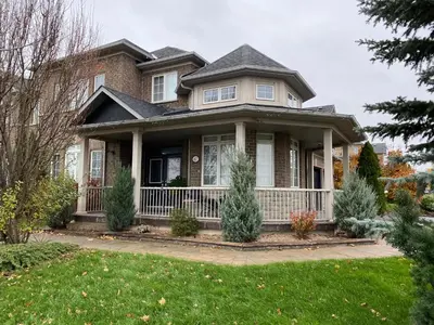 a house with a white fence in a yard at Aurora Executive Upscale Residence Three Bedrooms Three and Half Bathrooms in Aurora