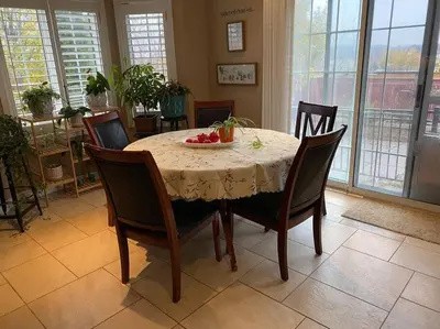 a dining room table with chairs and a bowl of fruit on it at Aurora Executive Upscale Residence Three Bedrooms Three and Half Bathrooms in Aurora