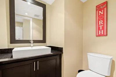 a bathroom with a white sink and a mirror at Luxurious Sierra Lane Escape in Blue Mountains