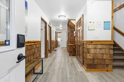 a hallway with wooden walls and stairs in a building at 12 Beds Sleep 16 Chalet with HotTub, 2min to Blue in Blue Mountains