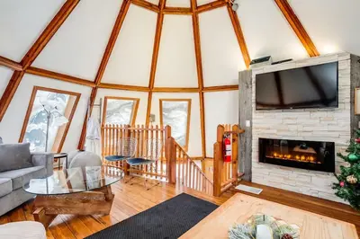 a living room with a fireplace and a tv at The Beehive w Hot Tub Sauna & Fireplace in Blue Mountains