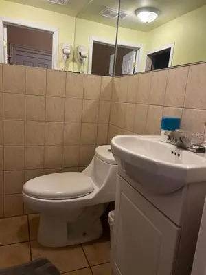 a bathroom with a toilet and a sink at Adas Guesthouse in Toronto