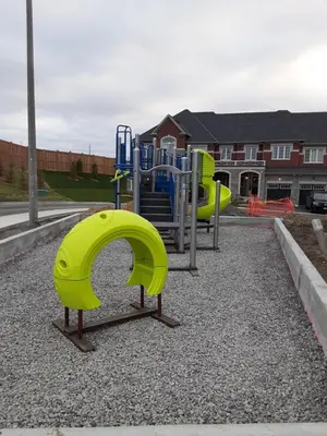 a playground with two slides at Close Property in Bowmanville