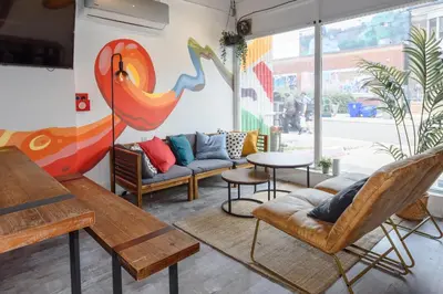 a living room with furniture and a large window at Samesun Toronto in Toronto