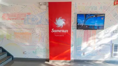 a wall with a mural of a map on it at Samesun Toronto in Toronto