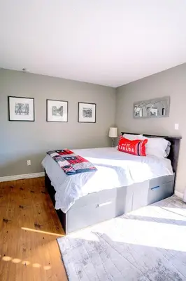 a bedroom with a large white bed with red pillows at Hillside BLUE MTN Family Loft @ North Creek Resort in Blue Mountains