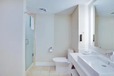 a white bathroom with a sink and a toilet at Living Water Resort & Spa in Collingwood