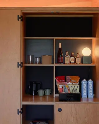 a cupboard with some food and items in it at Ace Hotel Toronto in Toronto