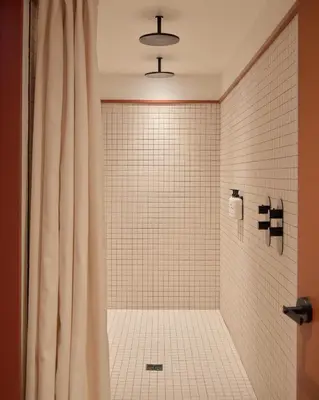 a bathroom with a shower with a shower curtain at Ace Hotel Toronto in Toronto
