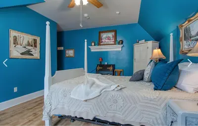 a blue bedroom with a bed with blue walls at Bristows Inn in Elmira