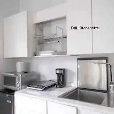 a kitchen with a sink and a coffee maker at Entire Queen Loft in Toronto