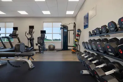 a gym with lots of treadmills and weights at Hampton Inn by Hilton Port Hope Cobourg in Port Hope