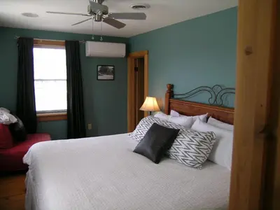 a bedroom with a bed and a ceiling fan at Emilyville Inn in Campbellford