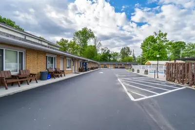 an empty parking lot in front of a building at Beach Club by Beach1 Motel in Wasaga Beach