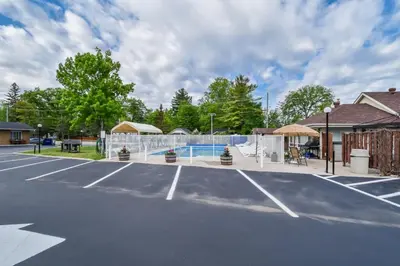 a tennis court with a net and a court at Beach Club by Beach1 Motel in Wasaga Beach