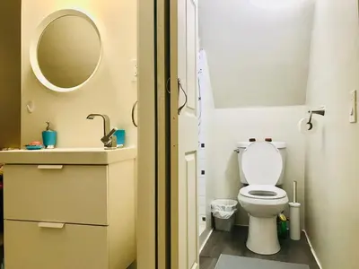 a small bathroom with a toilet and a sink at Cheerful residence in Niagara Falls