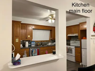 a kitchen with wooden cabinets and a kitchen main floor at Cheerful residence in Niagara Falls
