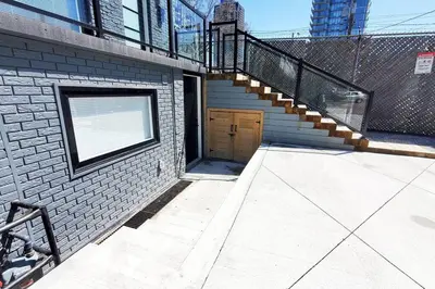 a stairway leading to a door in a brick building at Renovated Guest Suite Near The Lake & High Park in Toronto! in Toronto