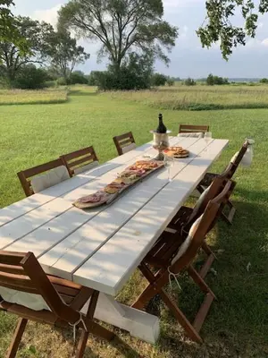 a long picnic table with chairs in a field at The Prince Edward County Church, A Unique Escape in Belleville