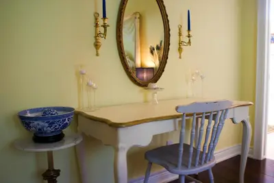 a dressing table with a mirror and a chair at Sapience Retreat & Apothecary in Niagara on the Lake