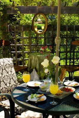 a table with plates of food and glasses of orange juice at Sapience Retreat & Apothecary in Niagara on the Lake