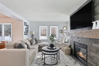 a living room with a couch and a fireplace at Mountain Walk Chalet Across From Blue Mtn Village in Blue Mountains