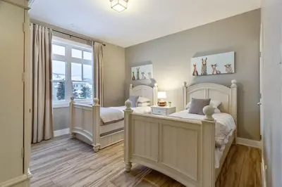 a bedroom with two beds and a window at Contemporary Chalet Steps to Blue Mountain Village in Blue Mountains