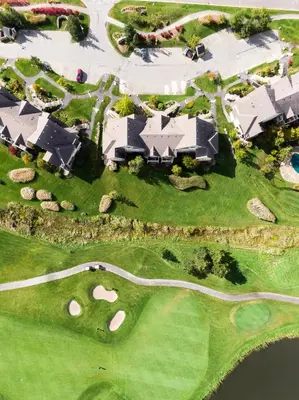 an overhead view of a golf course with a house at Contemporary Chalet Steps to Blue Mountain Village in Blue Mountains