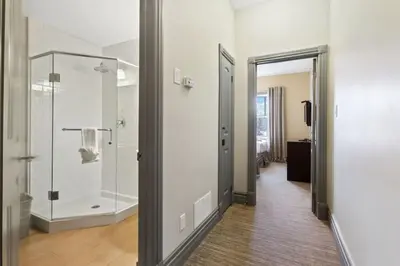a bathroom with a walk in shower and a glass door at Blue Mtn Getaway in Historic Snowbridge Chalet in Collingwood