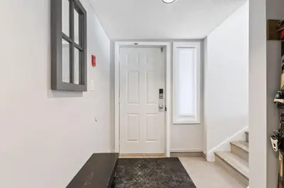 a hallway with a white door and a black rug at Condo With Blue Mtn Village In Your Backyard in Blue Mountains