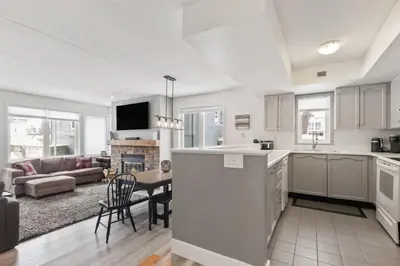 a kitchen and living room with a couch and a table at Condo With Blue Mtn Village In Your Backyard in Blue Mountains
