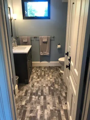a bathroom with a sink and a toilet and a window at Stone's Throw Stratford in Stratford