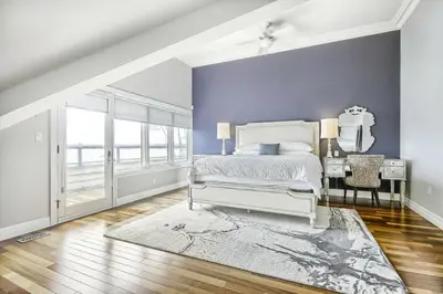 a bedroom with a bed and a table with a mirror at Family Lakeside Oasis in Innisfil