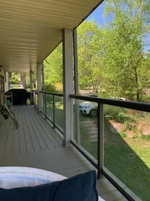 a porch with a bed and a view of a car at Family Lakeside Oasis in Innisfil
