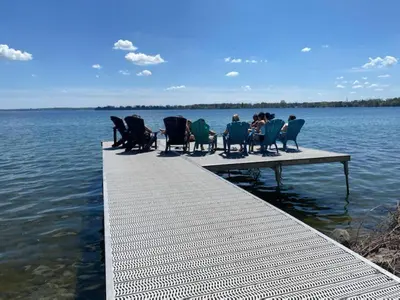 a group of people sitting on a dock in the water at Family Lakeside Oasis in Innisfil