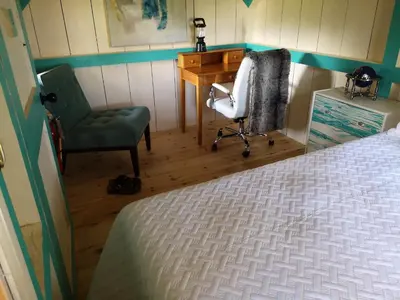 a bedroom with a desk and a chair and a bed at Dreamers Writing Farm, 3 Wooded Acres, Hepworth in Sauble Beach