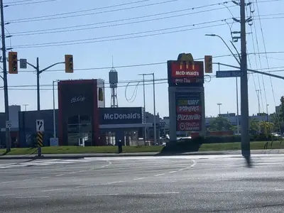 an empty intersection with a mcdonalds sign on a street at Home Stay near the Airport in Mississauga
