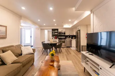a living room with a couch and a kitchen with a table at Luxurious and Spacious Apartment with 2 bedrooms and 2 Baths in Mississauga