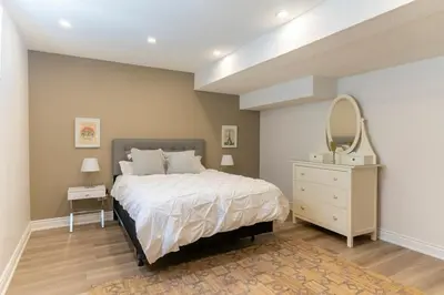 a bedroom with a bed with a mirror and a dresser at Luxurious and Spacious Apartment with 2 bedrooms and 2 Baths in Mississauga